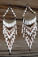 A pair of handmade beaded dangle earrings with white, brown, and cream beads.